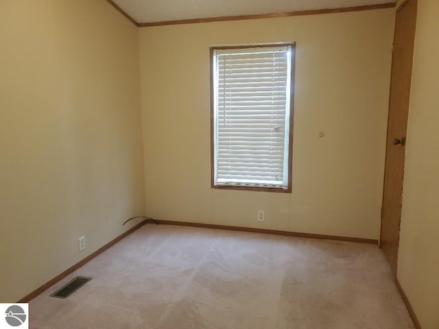 5232 E Broadway Lot 338, Mount Pleasant, MI 48858 - unfurnished room featuring light colored carpet, baseboards, and crown molding