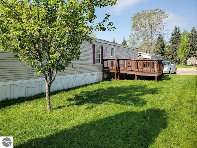 5232 E Broadway Lot 338, Mount Pleasant, MI 48858 - back of property featuring a deck and a yard