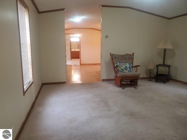 5232 E Broadway Lot 338, Mount Pleasant, MI 48858 - sitting room featuring crown molding, baseboards, carpet flooring, a wood stove, and vaulted ceiling