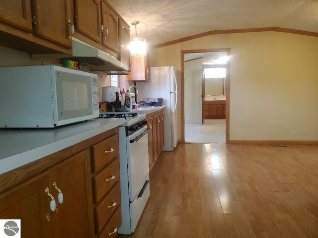 5232 E Broadway Lot 338, Mount Pleasant, MI 48858 - kitchen with white appliances, under cabinet range hood, brown cabinetry, crown molding, and light wood-style floors