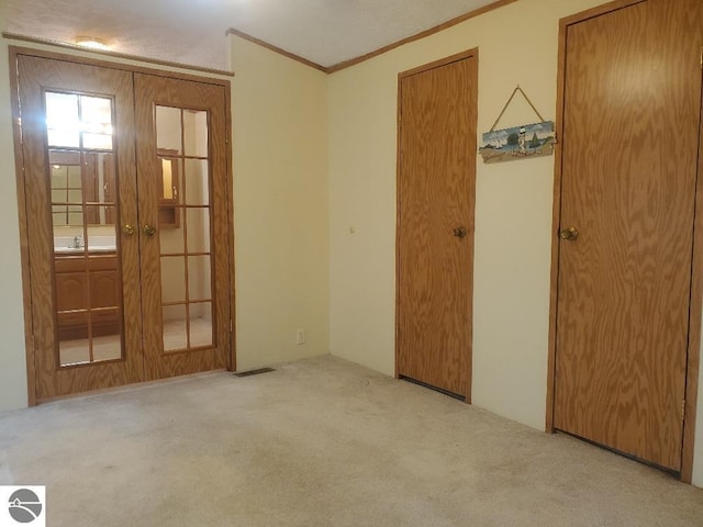 5232 E Broadway Lot 338, Mount Pleasant, MI 48858 - empty room featuring carpet floors, french doors, ornamental molding, and a sink