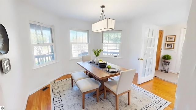 dining space featuring light wood-style flooring