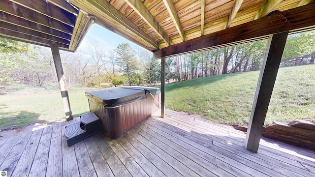 wooden terrace with a hot tub and a yard