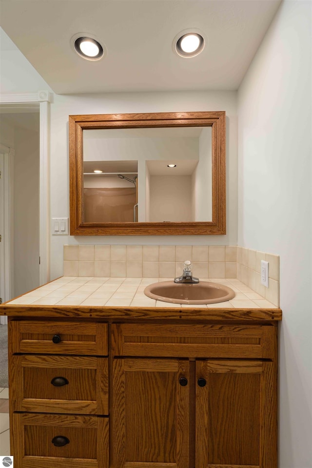 bathroom featuring vanity and decorative backsplash