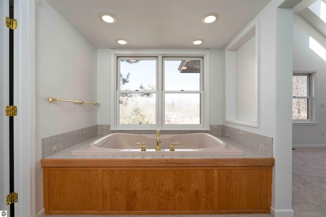 full bath with a bath, plenty of natural light, and recessed lighting