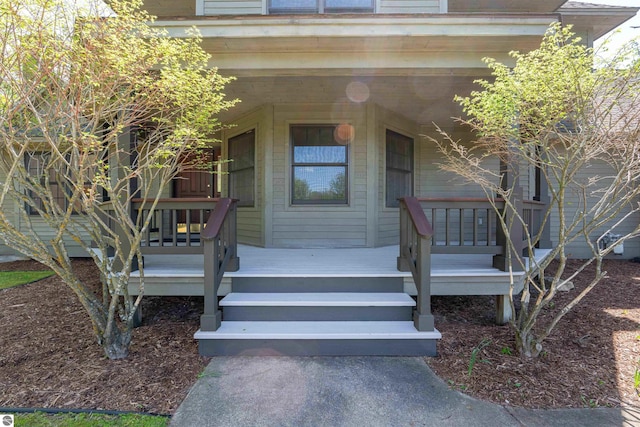 view of exterior entry featuring a porch