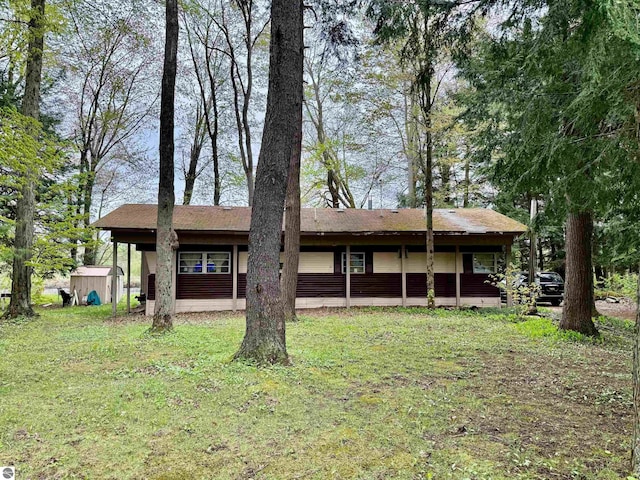 448 Autumn Rd, Cadillac, MI 49601 - view of front of home with a storage unit, an outbuilding, and a front yard