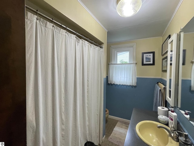 630 N State St, Alma, MI 48801 - full bath featuring toilet, ornamental molding, vanity, and baseboards