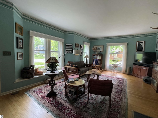 630 N State St, Alma, MI 48801 - living room featuring light wood-style flooring, ornamental molding, and baseboards