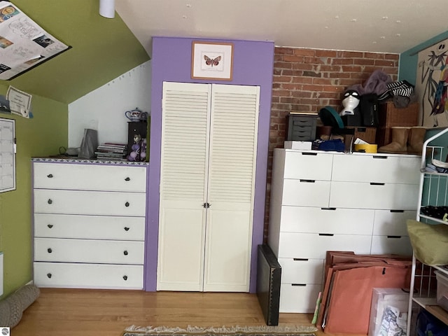 630 N State St, Alma, MI 48801 - bedroom featuring wood finished floors and lofted ceiling