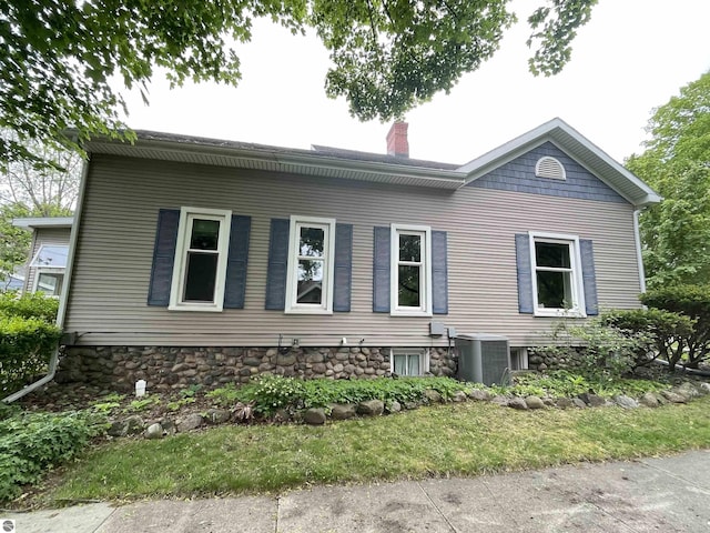 630 N State St, Alma, MI 48801 - view of property exterior featuring a chimney and central AC