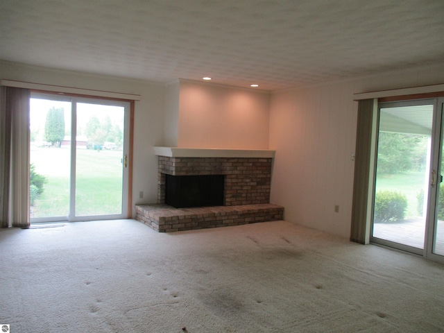 8481 N Luce Rd, Alma, MI 48801 - unfurnished living room with carpet floors, a fireplace, and recessed lighting
