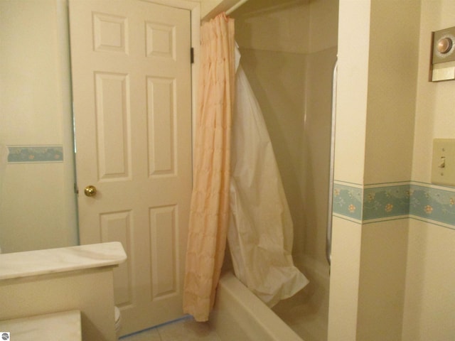 8481 N Luce Rd, Alma, MI 48801 - bathroom with a shower with shower curtain, toilet, and tile patterned flooring