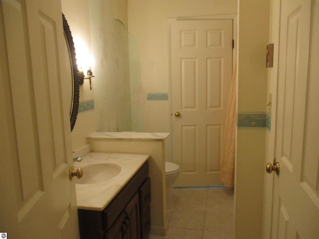 8481 N Luce Rd, Alma, MI 48801 - bathroom with vanity, tile patterned floors, and toilet