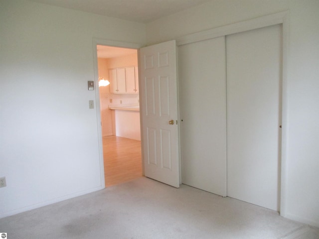 8481 N Luce Rd, Alma, MI 48801 - unfurnished bedroom featuring a closet and light colored carpet