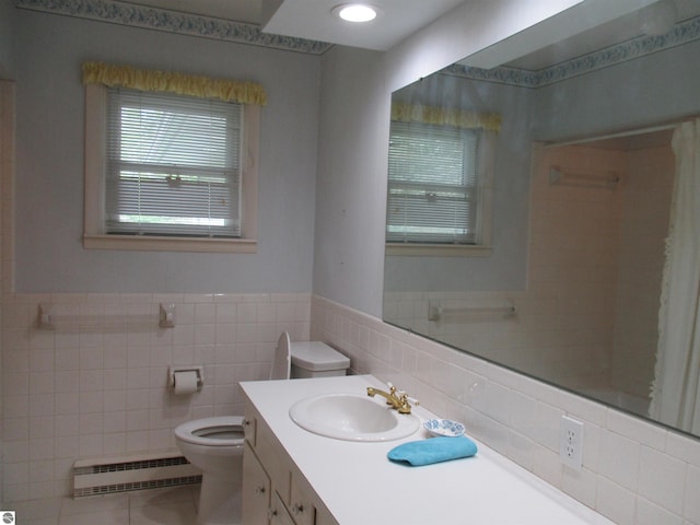 8481 N Luce Rd, Alma, MI 48801 - full bathroom featuring baseboard heating, tile walls, toilet, vanity, and tile patterned flooring