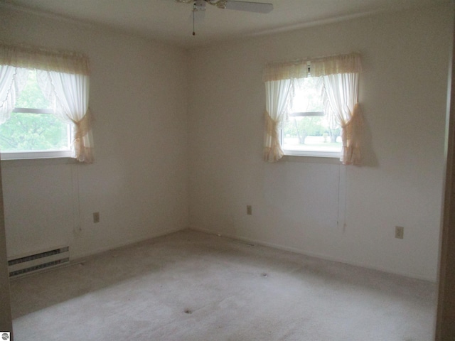 8481 N Luce Rd, Alma, MI 48801 - spare room with a baseboard heating unit, ceiling fan, and carpet