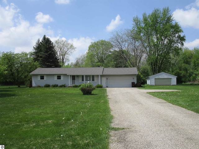 8481 N Luce Rd, Alma, MI 48801 - ranch-style home with a front yard, a garage, and view of wooded area