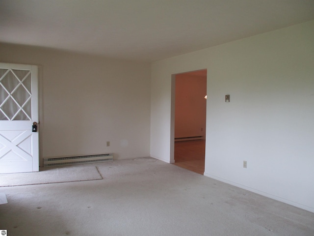 8481 N Luce Rd, Alma, MI 48801 - spare room with baseboard heating, carpet flooring, a baseboard radiator, and baseboards