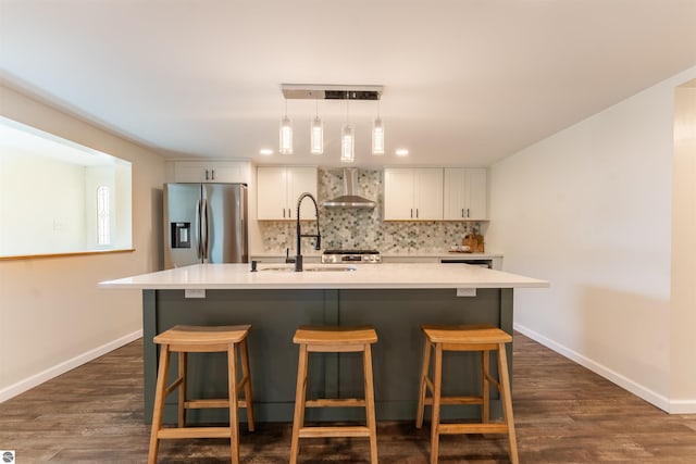 968 Barlow St, Traverse City, MI 49686 - kitchen featuring stainless steel fridge with ice dispenser, wall chimney exhaust hood, a sink, tasteful backsplash, and recessed lighting