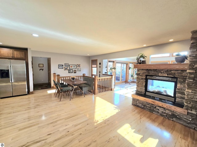 205 S Elm St, Suttons Bay, MI 49682 - living room featuring light wood-style flooring, a stone fireplace, plenty of natural light, and recessed lighting