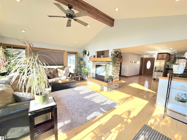 205 S Elm St, Suttons Bay, MI 49682 - living area with a fireplace, beamed ceiling, light wood-style flooring, ceiling fan, and high vaulted ceiling