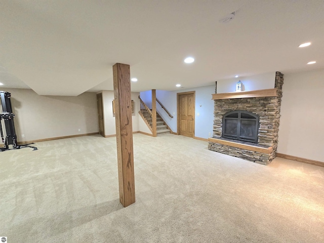 205 S Elm St, Suttons Bay, MI 49682 - unfurnished living room featuring carpet, recessed lighting, baseboards, stairs, and a stone fireplace