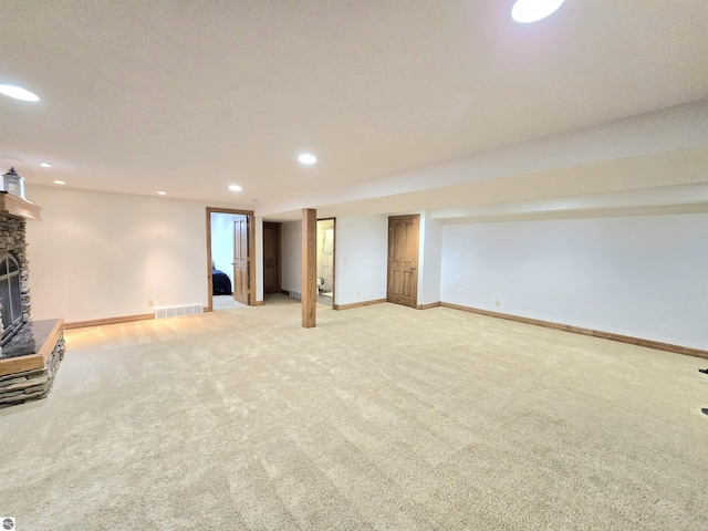 205 S Elm St, Suttons Bay, MI 49682 - finished basement featuring light colored carpet, a fireplace, baseboards, and recessed lighting