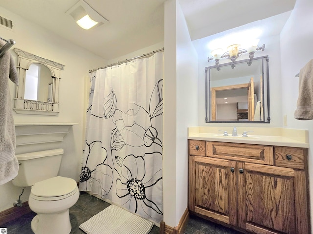 205 S Elm St, Suttons Bay, MI 49682 - bathroom with toilet, vanity, a shower with curtain, and baseboards
