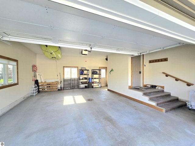 205 S Elm St, Suttons Bay, MI 49682 - garage featuring a garage door opener and baseboards