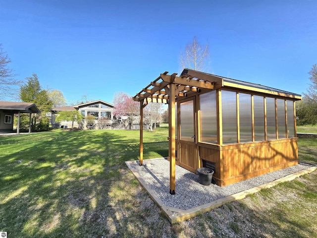 205 S Elm St, Suttons Bay, MI 49682 - view of green lawn with a greenhouse and an outbuilding