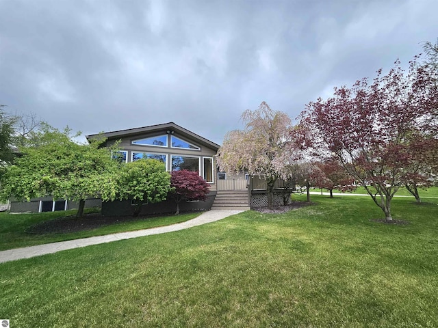 205 S Elm St, Suttons Bay, MI 49682 - view of front of home with a deck and a front lawn