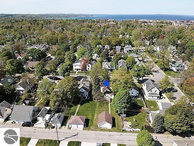 aerial view of property and surrounding area with nearby suburban area