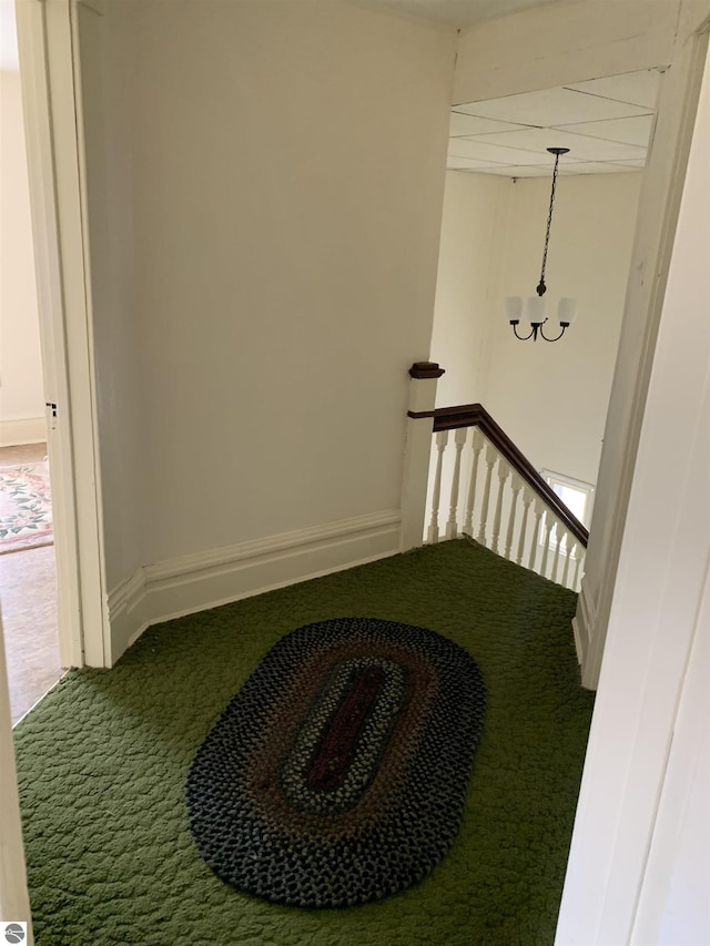 hall with carpet and an upstairs landing