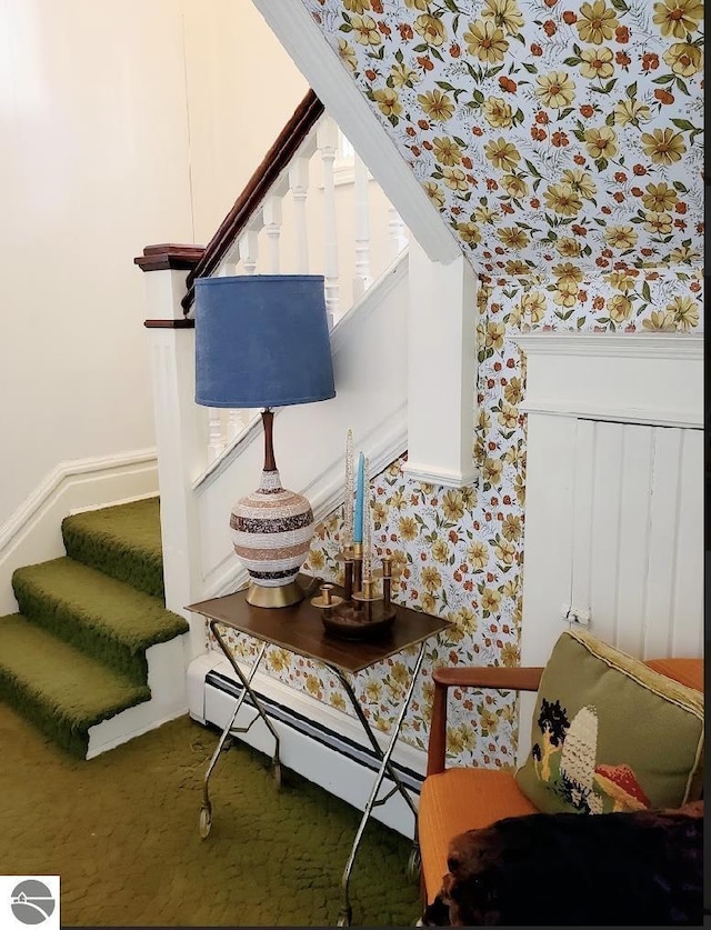 living area featuring wallpapered walls, stairway, a baseboard heating unit, and carpet floors
