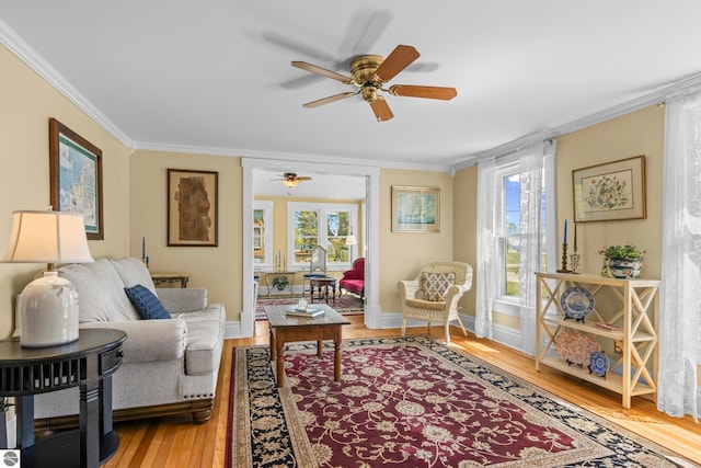 302 N Rose St, Northport, MI 49670 - living room with crown molding, ceiling fan, wood finished floors, healthy amount of natural light, and baseboards
