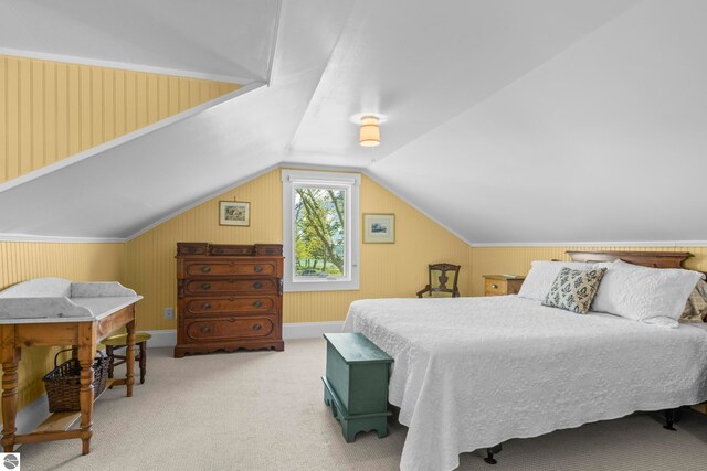 302 N Rose St, Northport, MI 49670 - bedroom with carpet floors, lofted ceiling, and wood walls