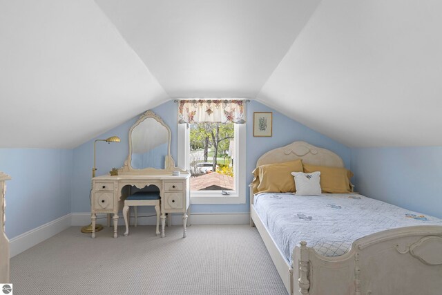 302 N Rose St, Northport, MI 49670 - carpeted bedroom featuring lofted ceiling and baseboards