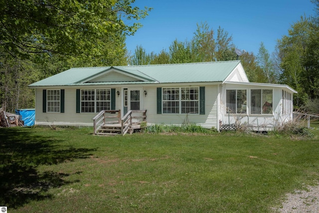 2250 N Coleman Rd, Coleman, MI 48618 - view of front of property featuring metal roof, a front yard, and a sunroom