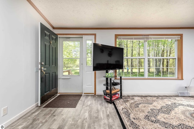 2250 N Coleman Rd, Coleman, MI 48618 - foyer featuring crown molding, wood finished floors, a textured ceiling, and baseboards
