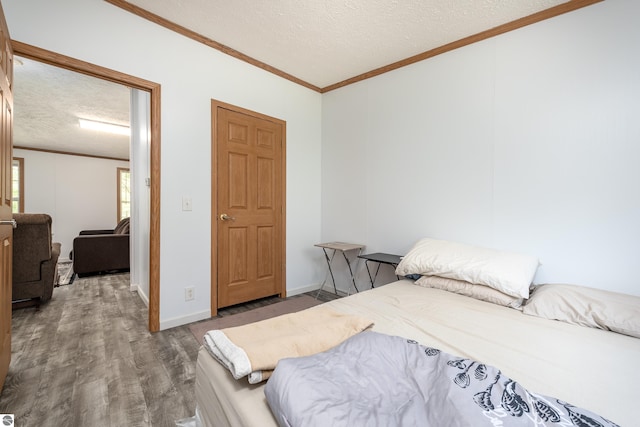2250 N Coleman Rd, Coleman, MI 48618 - bedroom with a textured ceiling, wood finished floors, crown molding, and baseboards
