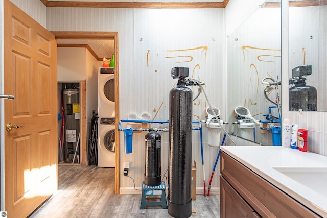2250 N Coleman Rd, Coleman, MI 48618 - utility room featuring stacked washer and clothes dryer and water heater