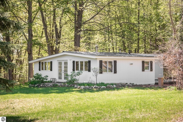 11199 Center Rd, Traverse City, MI 49686 - single story home with french doors and a front lawn