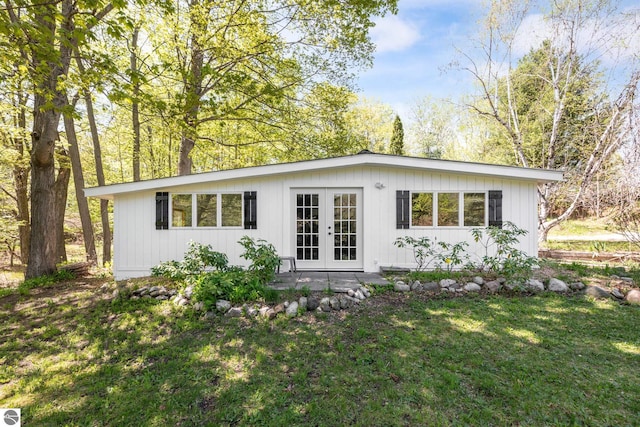11199 Center Rd, Traverse City, MI 49686 - rear view of property featuring french doors and a lawn