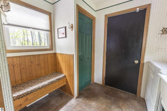 entryway with wallpapered walls and wainscoting