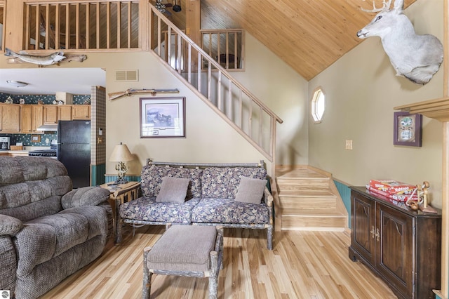 living room with stairway, light wood-style floors, wooden ceiling, and high vaulted ceiling