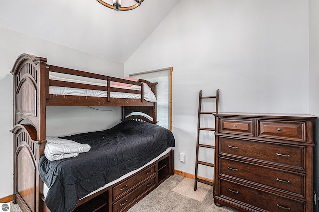 3290 Sumac Trl, Frankfort, MI 49635 - bedroom featuring light colored carpet, baseboards, and lofted ceiling