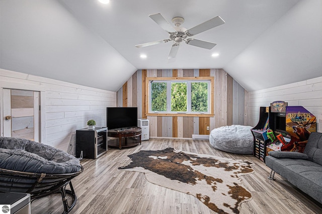 3290 Sumac Trl, Frankfort, MI 49635 - living room featuring wood walls, vaulted ceiling, wood finished floors, and ceiling fan