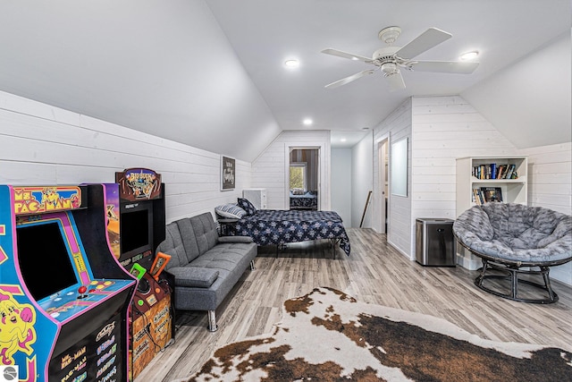 3290 Sumac Trl, Frankfort, MI 49635 - bedroom featuring wood walls, vaulted ceiling, wood finished floors, and ceiling fan