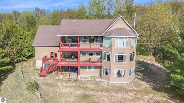 3290 Sumac Trl, Frankfort, MI 49635 - back of property featuring a balcony, stairs, a forest view, and a wooden deck